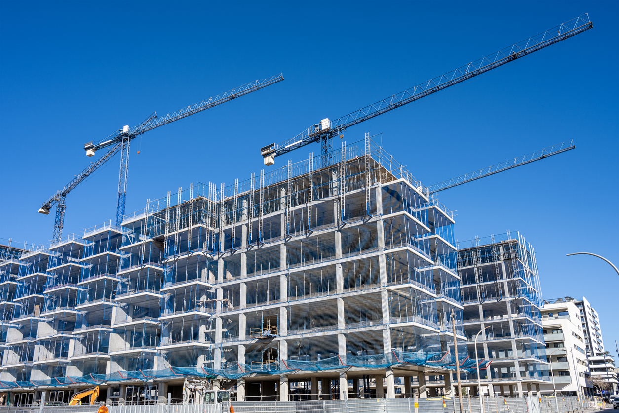 Construction health and safety software in use on an Australian building site with workers wearing PPE